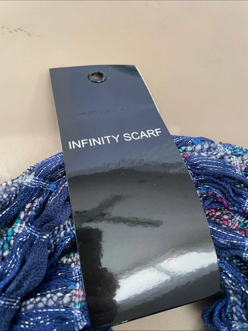 Infinity scarf new in package. Colors blue, red teal and silver. Great accent to